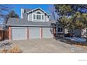 Charming two-story house with three-car garage and brick accents at 11563 W 67Th Ave, Arvada, CO 80004