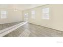 Sunlit living area featuring hard wood floors and a light neutral paint at 1431 Vantage Pkwy, Berthoud, CO 80513