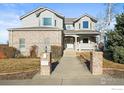 Inviting two-story home with a brick accent, landscaped front yard, and charming entrance at 1750 Little Bear Dr, Longmont, CO 80504