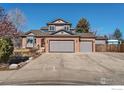 Spacious home with a three-car garage and wide driveway, perfect for families and entertaining guests at 1826 Little Bear Ct, Longmont, CO 80504