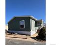 Exterior view of a home featuring green siding and a covered porch at 212 Skylark Cir, Lafayette, CO 80026