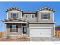 Charming two-story home featuring a gray exterior, covered front porch, and attached two-car garage at 2539 Alto St, Fort Lupton, CO 80621