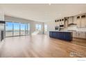 Bright and airy living room with hardwood floors, large windows, and sliding glass doors opening to the exterior at 2978 Newfound Lake Rd, Berthoud, CO 80513