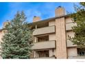 Exterior of a condo featuring balconies, textured stucco and mature trees at 3035 Oneal Pkwy # 36, Boulder, CO 80301