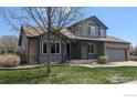 Charming two-story home with a well manicured lawn and brick accents at 3232 Mariner Ln, Longmont, CO 80503