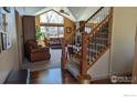 Cozy living room with large windows, stone fireplace and staircase at 3232 Mariner Ln, Longmont, CO 80503