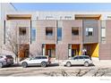 Modern exterior view of a multi-unit brick and metal clad building with covered entryways and parking spaces at 3233 Tejon St # 101, Denver, CO 80211