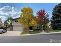 Charming home featuring mature trees and landscaped front yard, enhancing curb appeal at 3549 Columbia Dr, Longmont, CO 80503