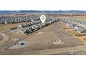 Aerial view of a residential area showcasing houses, a dog park, and picturesque mountain views at 464 Wagon Bend Rd, Berthoud, CO 80513