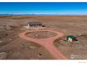 Expansive view of the property highlighting the home, gravel driveway, and surrounding acreage at 47705 Private Road 19 Rd, Elizabeth, CO 80107