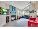 Open living room features vaulted ceilings, a fireplace, and large windows at 4881 White Rock Cir # F, Boulder, CO 80301