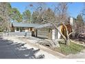 Side view of the home showcasing xeriscaping, metal roofing, modern garage door, and attractive curb appeal at 503 Kalmia Ave, Boulder, CO 80304