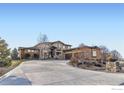 Impressive home with a long driveway, a large attached garage, and beautiful stonework at 5763 Pelican Shores Dr, Longmont, CO 80504