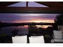 Picturesque sunset view from the outdoor patio overlooking a tranquil lake at 5763 Pelican Shores Dr, Longmont, CO 80504