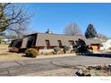 Street view showcasing a unique roofline with the garage on the right side of the house at 58 Curtis Ct, Broomfield, CO 80020