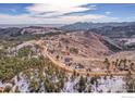 Aerial view of property, mountains, and terrain, showcasing the home's rural setting at 6191 Sunshine Canyon Dr, Boulder, CO 80302