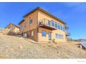 Modern home exterior featuring a multi-level design, balconies, stone accents, and hillside setting at 6191 Sunshine Canyon Dr, Boulder, CO 80302