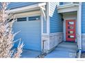 Close up of the front exterior showing the brick base, garage, and red front door at 651 Stonebridge Dr, Longmont, CO 80503