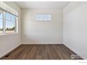 Bright bedroom with wood flooring and large window at 1046 Scotts Peak Dr, Berthoud, CO 80513