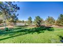 A beautiful view overlooking a grassy area with many trees and walking paths at 1251 S Monaco Pkwy, Denver, CO 80224