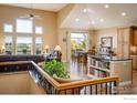 Open-concept living space with high ceilings, lots of natural light and a cozy dining area at 13943 W 87Th Ln, Arvada, CO 80005