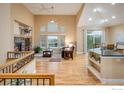 Bright, open living space with high ceilings, large windows, hardwood floors, and modern finishes at 13943 W 87Th Ln, Arvada, CO 80005