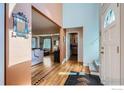 Bright foyer with hardwood floors, modern staircase, and open view to the living area at 1555 Sumac Ave, Boulder, CO 80304