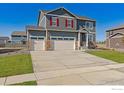 Inviting two-story home showcasing a three-car garage, well-manicured lawn, and charming curb appeal at 1884 Westport Ave, Berthoud, CO 80513