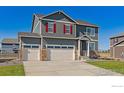 Inviting two-story home showcasing a three-car garage, well-manicured lawn, and charming curb appeal at 1884 Westport Ave, Berthoud, CO 80513