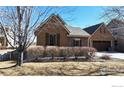 Charming single-Gathering home featuring a stone facade, brown shutters, tidy landscaping, and a well-maintained front yard at 2238 Calais Dr # B, Longmont, CO 80504