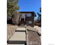 Exterior shot showcasing the building with a private entrance and concrete steps leading to it at 2241 Dexter Dr # 2, Longmont, CO 80501