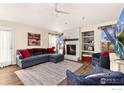 Inviting living room featuring a brick fireplace, plush seating, and lots of natural light at 2559 Serena Dr, Mead, CO 80542