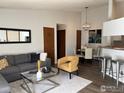 Open-concept living room with modern furniture, adjacent dining, and kitchen areas at 2800 Kalmia Ave # 320, Boulder, CO 80301