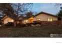 Charming single-story ranch with brick accents and landscaped front yard at twilight at 330 Hopi Pl, Boulder, CO 80303