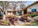 Landscaped front yard with stone pathway leading to a charming brick and beige single-story home at 330 Hopi Pl, Boulder, CO 80303