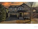 Beautiful two-story home featuring a covered front porch, and neutral color palette at sunset at 3418 Fantasy Pl, Castle Rock, CO 80109