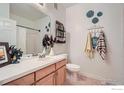 Bright bathroom featuring a vanity with ample storage, decorative accents, and a shower with tub at 3575 Boulder Cir # 101, Broomfield, CO 80023