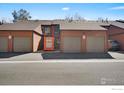 Townhome exteriors shows private garages with brown siding and asphalt driveway; parking space at unit number six at 449 Wright St # 6, Lakewood, CO 80228