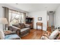 Inviting living room filled with natural light from large windows, creating a warm and welcoming atmosphere at 6167 Newland St, Arvada, CO 80003