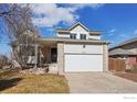 Inviting two-story home boasting a brick-accented garage and a cozy front porch at 7089 W Polk Pl, Littleton, CO 80123