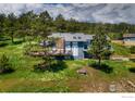 Beautiful home with a spacious deck is surrounded by lush greenery, offering a serene setting at 8483 Thunderhead Dr, Boulder, CO 80302