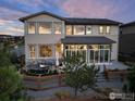 A beautiful backyard deck featuring outdoor furniture and a fire pit at 90 Moonrise Ct, Erie, CO 80516