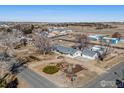 Expansive aerial view of a single-story home with a large yard and gravel driveway at 9752 Sierra Vista Rd, Longmont, CO 80504