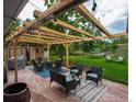 Outdoor patio with comfortable seating, a pergola with string lights, and a spacious backyard at 1011 Vivian Cir, Boulder, CO 80303