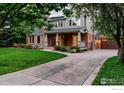 Charming two-story home with a welcoming front porch, landscaped lawn, and private driveway at 1107 Juniper Ave, Boulder, CO 80304