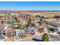 A bird's-eye view shows the home surrounded by a quiet neighborhood with trees at 1109 E 7Th Ave Cir, Broomfield, CO 80020