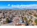 An aerial view reveals a home nestled in a suburban neighborhood with mountain views at 1109 E 7Th Ave Cir, Broomfield, CO 80020