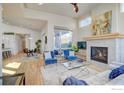 Bright living room featuring a fireplace, plush rug, and hardwood floors with open layout at 1324 Snowberry Ln, Louisville, CO 80027