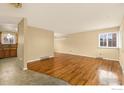 Bright and airy living room featuring hardwood floors and seamless flow to the kitchen at 1614 Meeker Dr, Longmont, CO 80504