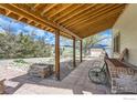 Enjoy outdoor living on this expansive patio with a stylish pergola and cozy seating area at 16450 Dakota Ridge Rd, Longmont, CO 80503